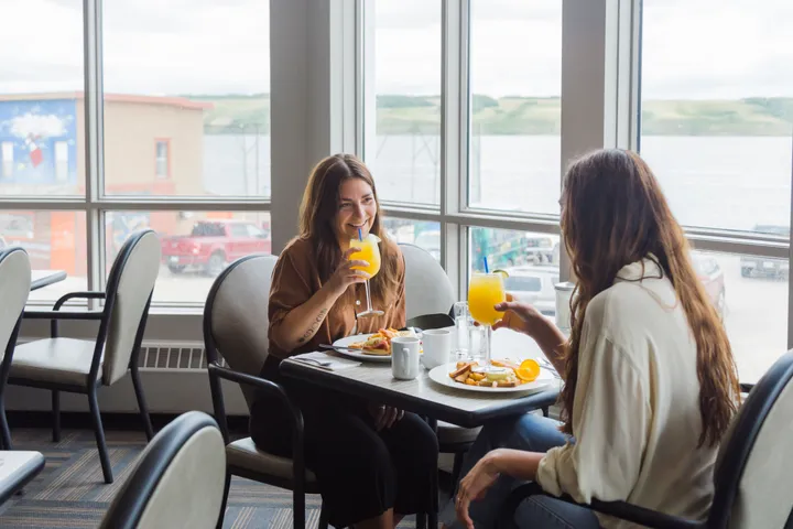 friends enjoying meal at water's edge restaurant