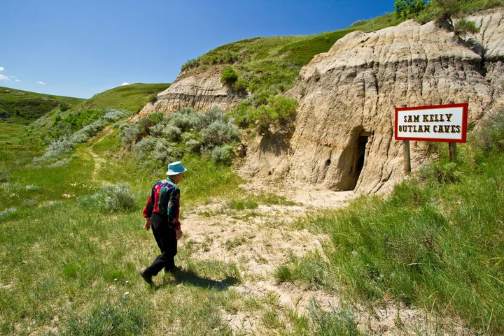 man walking by outlaw caves